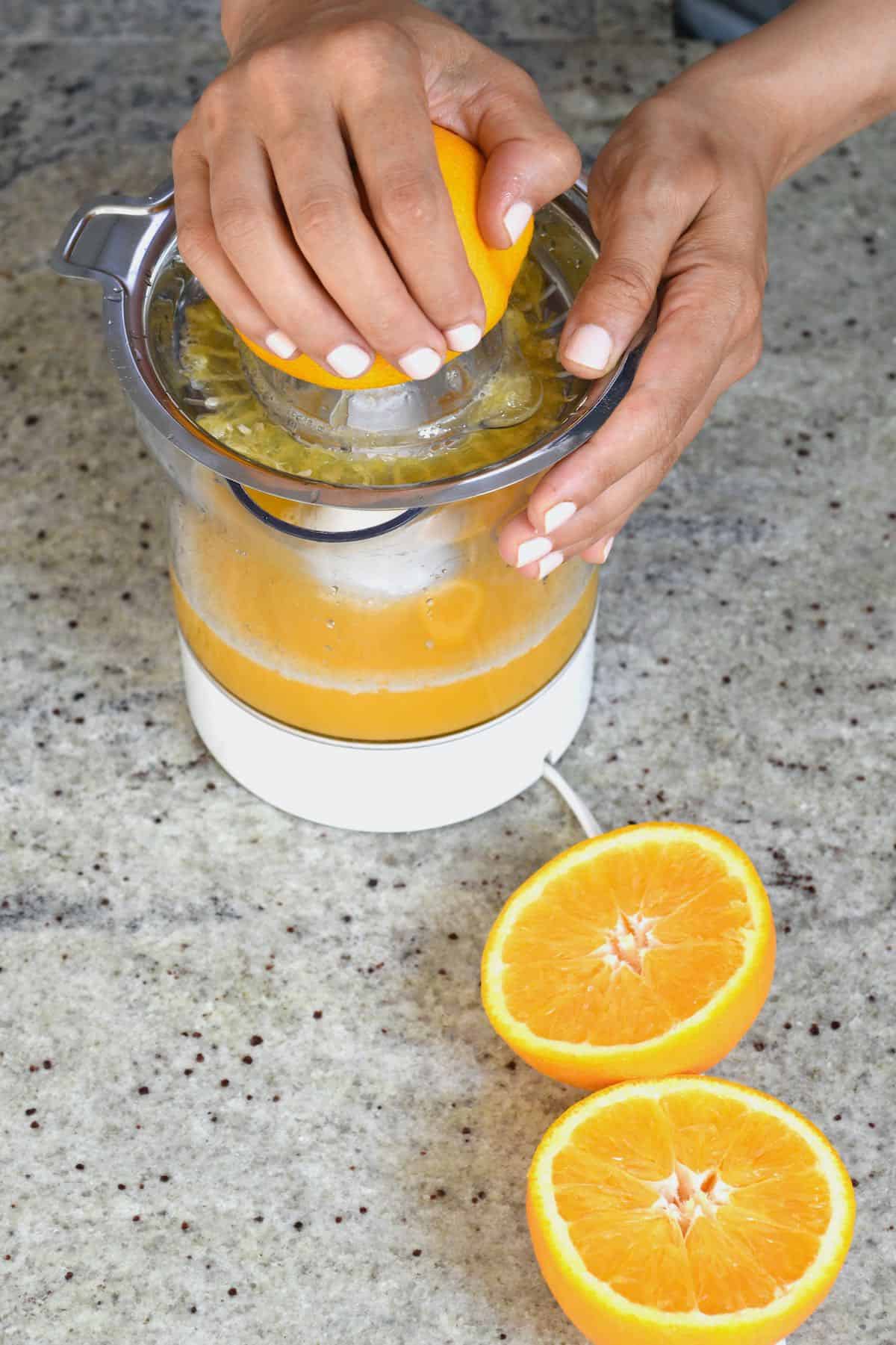 https://www.alphafoodie.com/wp-content/uploads/2021/07/Pineapple-Orange-Juice-Juicing-oranges.jpeg