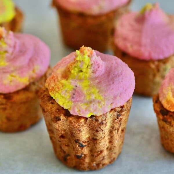 Savory muffin topped with rainbow hummus frosting
